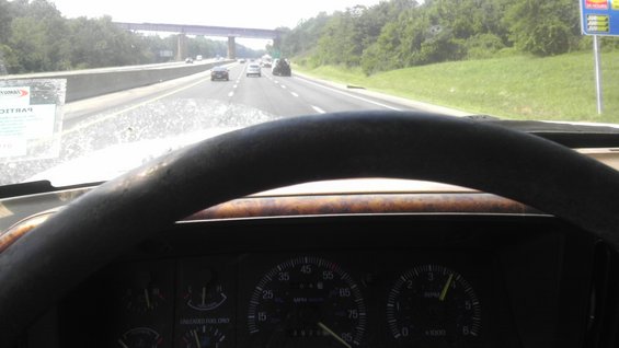 1989 Ford Bronco interior dashboard with wood trim steering wheel and speedometer