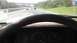 1989 Ford Bronco - View from inside a 1989 Ford Bronco on the highway, showing the dashboard and steering wheel.