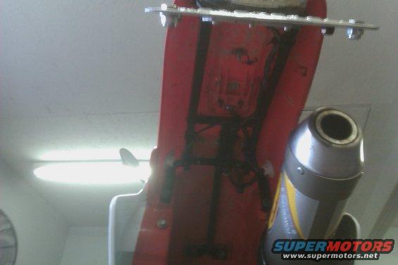 Motorcycle exhaust pipe with yellow stripe and red bodywork
