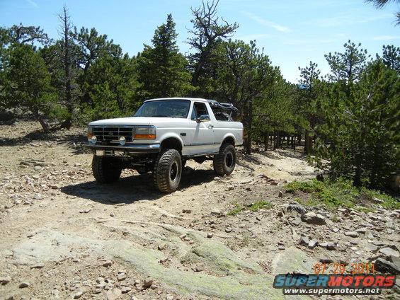 White 1996 Ford Bronco on a rocky trail, 3q-front view
