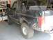 1995 Ford Bronco - This black Ford Bronco has significant body damage and appears to be in a garage.