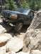 1995 Ford Bronco - A Ford Bronco maneuvers through a challenging rocky terrain, its off-road capabilities.