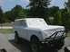 1978 International Scout II - A white 1978 International Scout II is parked outside, with its windows taped off in preparation for a paint job.