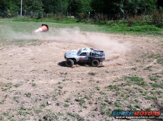 Remote control truck kicking up dust on a dirt track