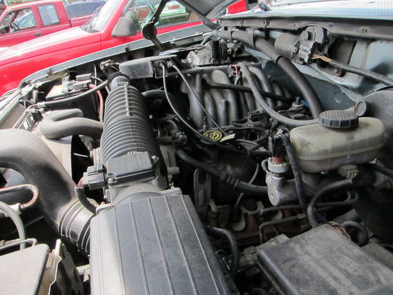 Engine bay with air intake and brake fluid reservoir visible