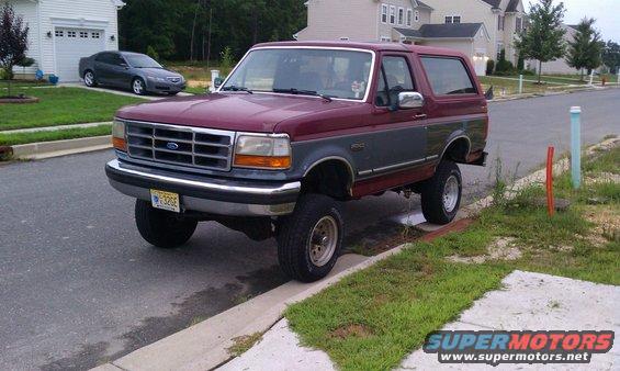 Maroon and grey 1993 Ford Bronco parked on street