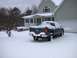 1982 Chevrolet Camaro - Pickup truck parked in front of a house during a snowfall.