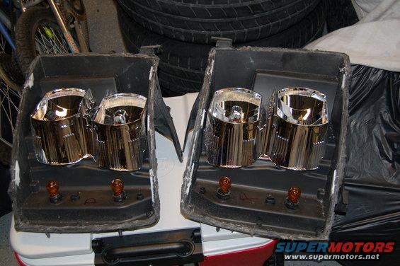 Pair of chrome projector headlights with amber bulbs removed from vehicle