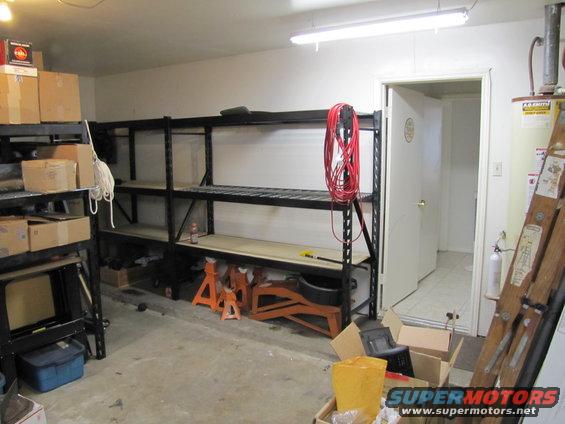 Garage interior with storage shelves, boxes, and tools