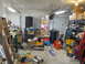 1993 Ford F-250 - A cluttered garage scene with various items including stacked tires, boxes, and exhaust pipes, suggesting a workshop or storage area.