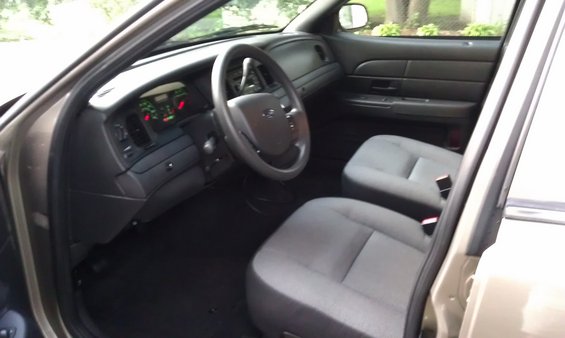 Interior view of a 2007 Ford Crown Victoria, showing the dashboard, steering wheel, and front seats