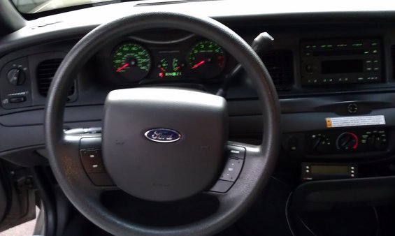 2007 Ford Crown Victoria interior dashboard with steering wheel, instrument cluster, and radio