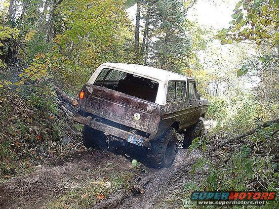 1978 Ford Bronco stuck in mud, rear 3/4 view