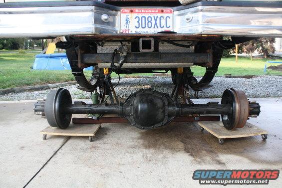 Rear axle assembly on dollies beneath a vehicle bumper with Ohio license plate 308XCC