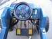1985 Ford F-150 - Interior view of a blue toy truck, showing the steering wheel and dashboard controls.