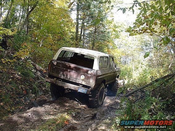 1978 Ford Bronco on a muddy trail, rear view