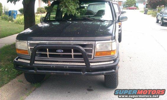 Black Ford Bronco with a brush guard, parked on a street