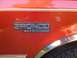 1996 Ford Bronco - Close-up of the Bronco XLT emblem on a red 1996 Ford Bronco.