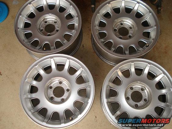 Four silver alloy wheels with a 10-spoke design. One wheel has a 'Ford' logo visible