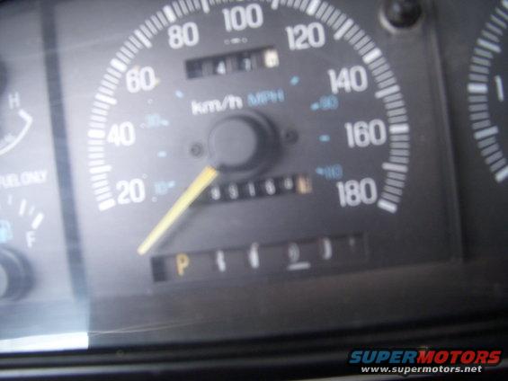 Dashboard gauges showing 65164 miles, P gear, and speedometer up to 180 mph
