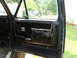 1986 Ford Bronco - Interior view of a vehicle's black door panel, showing wear and tear.