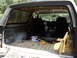 1986 Ford Bronco - The interior of a 1986 Ford Bronco is visible, including the front seats and the cargo bed.