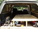 1986 Ford Bronco - Tools and supplies are organized in the rear of the vehicle, with a custom wooden platform built for storage.