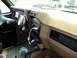 1986 Ford Bronco - The interior of a 1986 Ford Bronco shows aftermarket gauges and a modern stereo system.