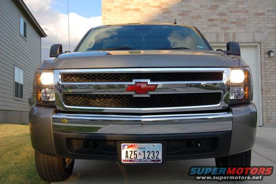 Front view of a gray Chevrolet pickup truck with a red bowtie emblem on the grille. Texas license plate AZ5 1232