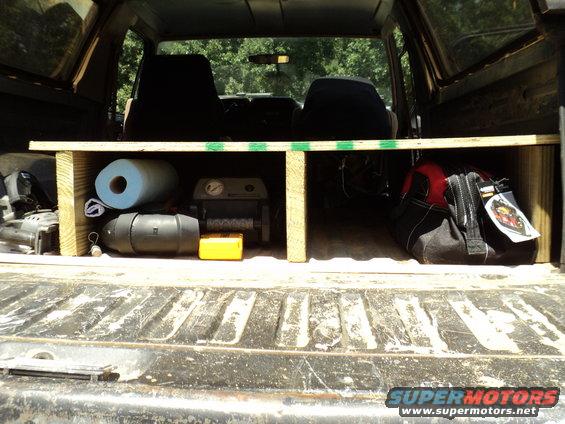 Interior cargo area with tools, paper towels, and a red and black bag