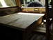 1986 Ford Bronco - Custom plywood platform installed in the cargo area of a vehicle, spare tire visible.