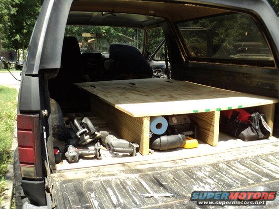 1986 Ford Bronco interior with wooden platform and tools