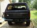 1986 Ford Bronco - Rear view of a black Ford Bronco, showing its bumper and a Mercury Marine sticker.