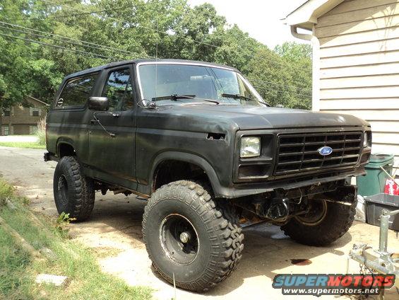 Black lifted Ford Bronco parked outdoors, front grille visible