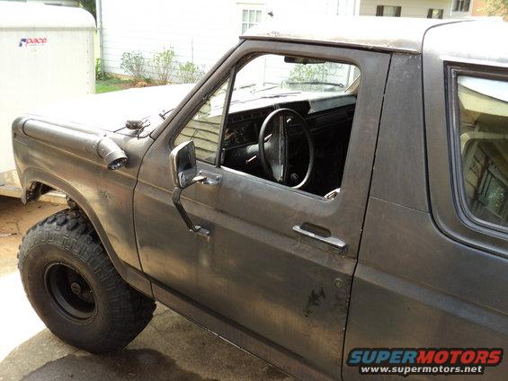 Gray Ford Bronco with off-road tires and snorkel, seen from the front-side
