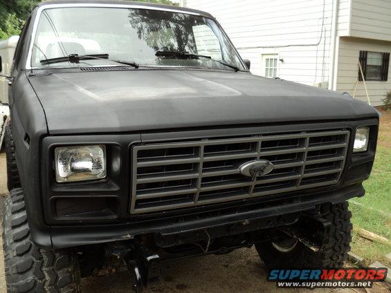 Black 1986 Ford Bronco front end with chrome grille and square headlights