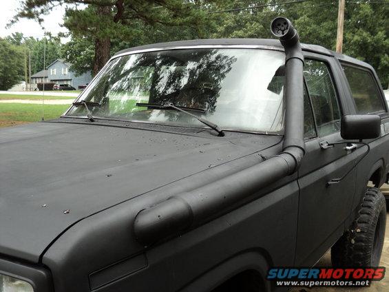 Black 1986 Ford Bronco with snorkel and off-road tires, 3/4 front view