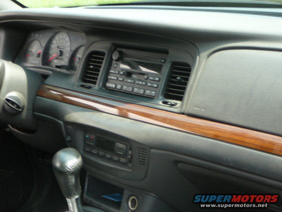 1999 Mercury Grand Marquis interior dashboard with wood trim and radio
