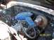 1978 Ford Bronco - The engine compartment shows various hoses, wiring, and a blue air filter housing.