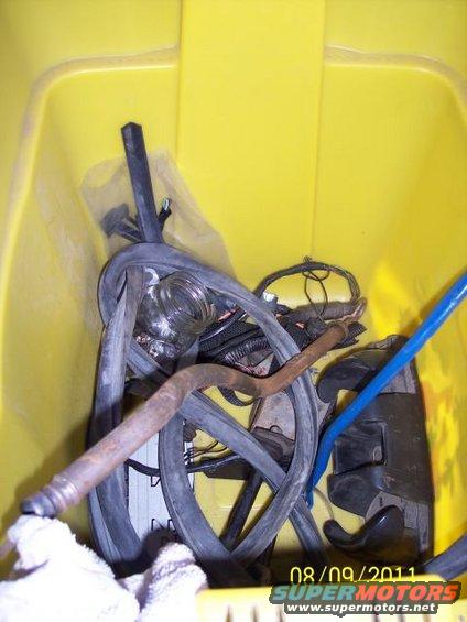 Bundle of hoses and wires in a yellow bin. Date stamp shows 08/09/2011
