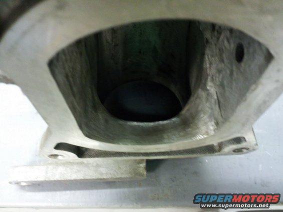 Close-up of an engine intake manifold port, showing internal casting