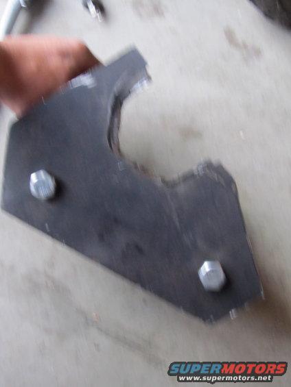 Metal bracket with two hex bolts, held by a hand