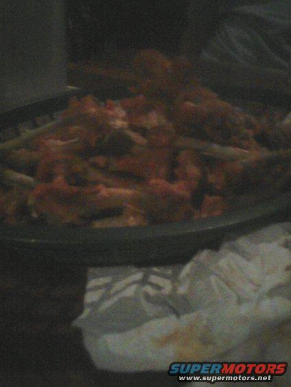 Food in a dark bowl with some green items mixed in