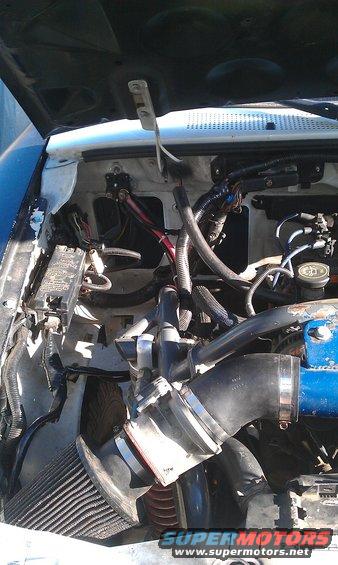 Engine bay with aftermarket air intake and blue engine block