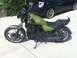 2002 Kawasaki Ninja - A green motorcycle is parked on a concrete surface next to a black car.