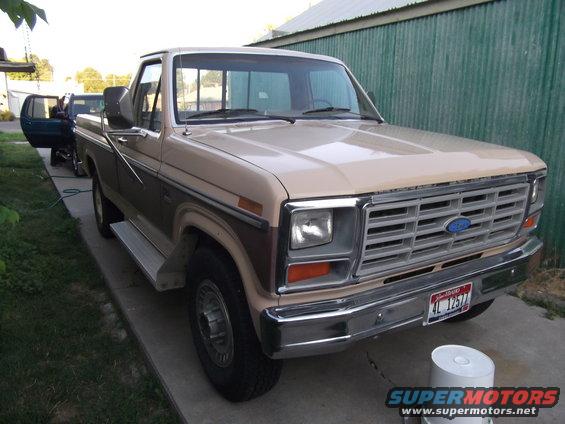 1985 Ford F-250 pickup truck parked on driveway, front 3/4 view