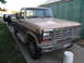 1985 Ford F-250 - This 1985 Ford F-250 pickup truck is parked in front of a green building.