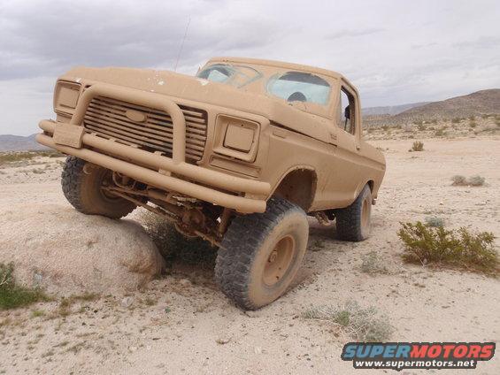 Tan Ford F-Series truck on a rock in the desert