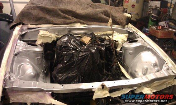 1987 Mazda RX-7 engine bay with engine covered in black plastic bags