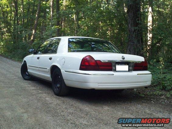 White 2000 Mercury Grand Marquis parked on a dirt road, rear view